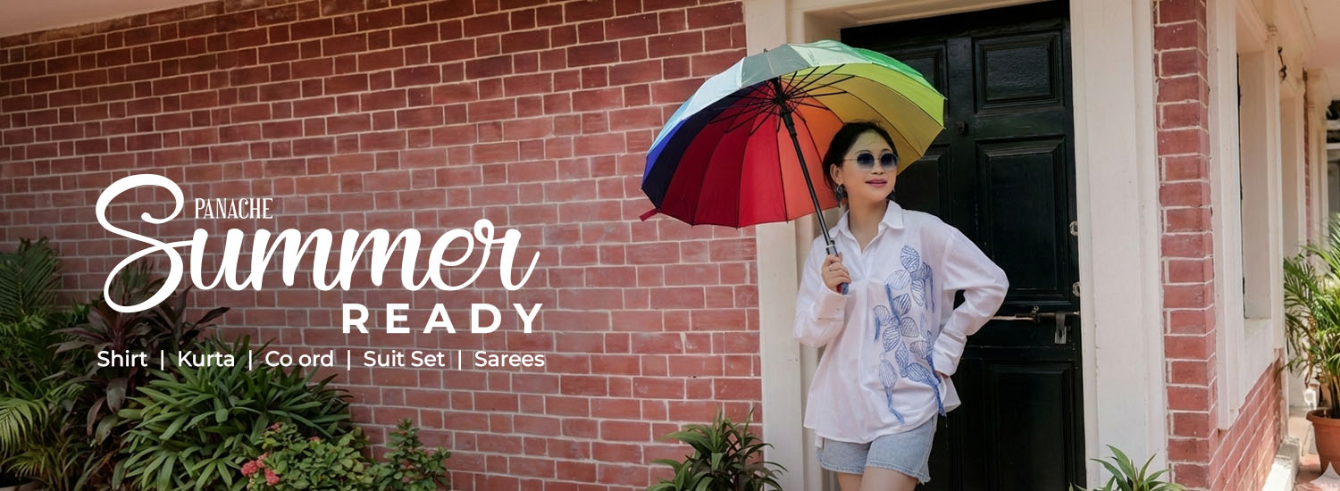 Person holding a colorful umbrella in front of a brick building with 'Summer Ready' text overlay.