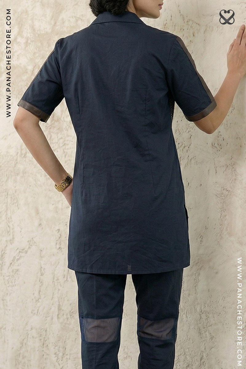 Person wearing a navy blue kurta with matching pants against a light beige background.