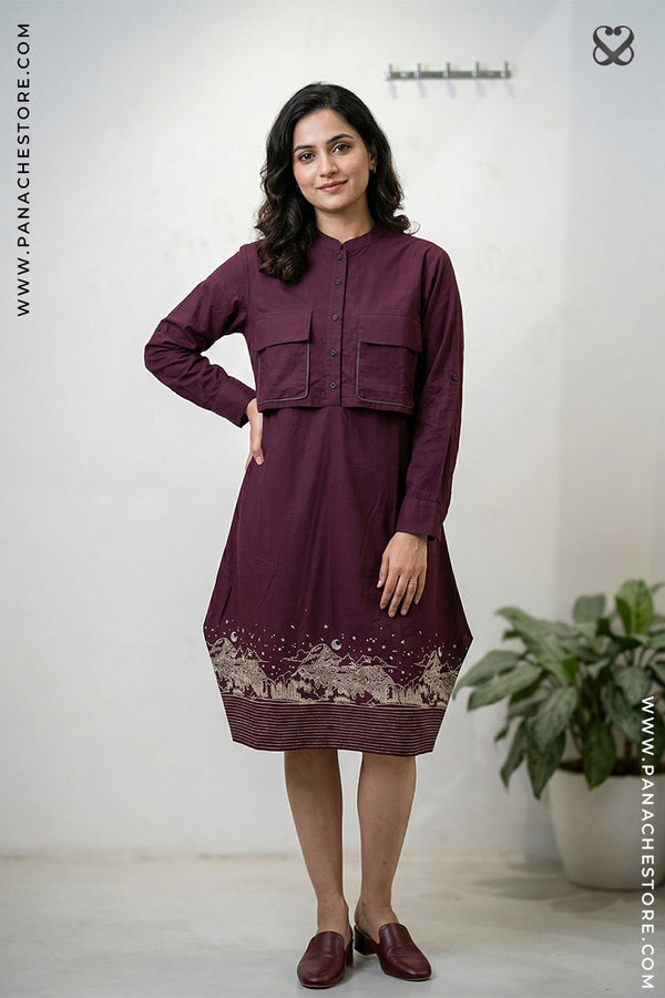 Woman wearing a maroon dress with lace details in a minimalistic setting