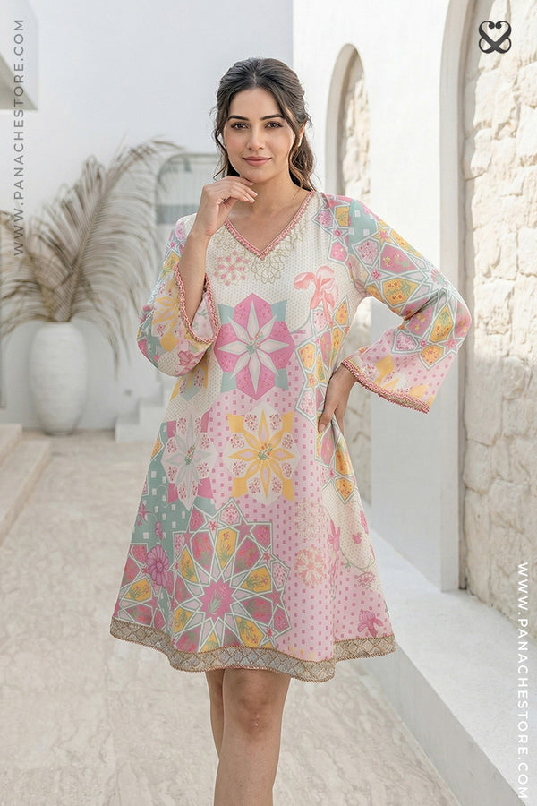 Woman wearing a colorful floral dress in an outdoor setting